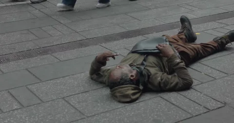 Time Square NYPD Confronts Homeless Man Sleeping On the Ground Stock Footage 246853356