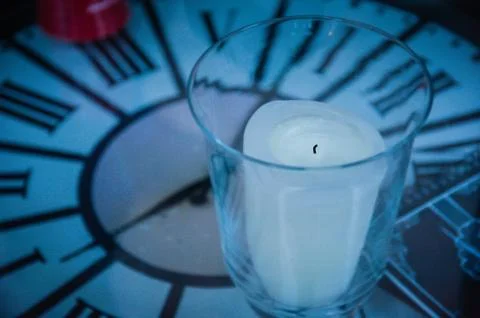 Time symbol with clock table and candle Fotos de archivo