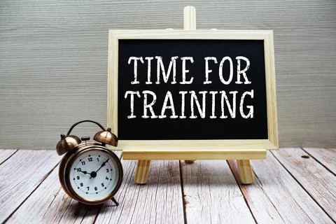 Time For Training text written on chalkboard with alarm clock on wooden bac.. 写真素材