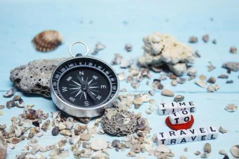 Time to Travel. Idea for tourism with compass on the sand with corals on the Stock Photos