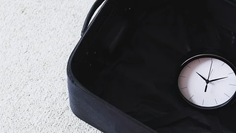 Time to travel or delay during a trip, empty suitcase with clock in it and ca Video stock 123741842