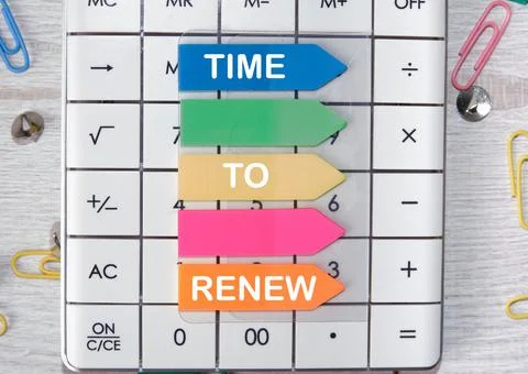 Time to update the label on the stickers lying on the white calculator Stock Photos