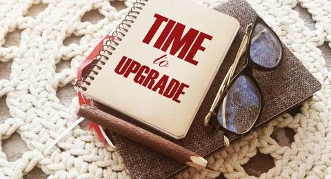 Time to upgrade text on notebook, glasses and pen. Business renew concept. Foto stock