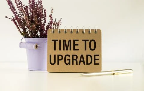 TIME TO UPGRADE text on notebook with office supplies on white background Stock Photos
