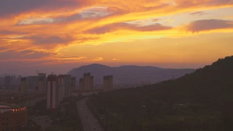 Time video of sunset sky with buildings and road traffic vehicles at dusk  Stock Footage 160877189