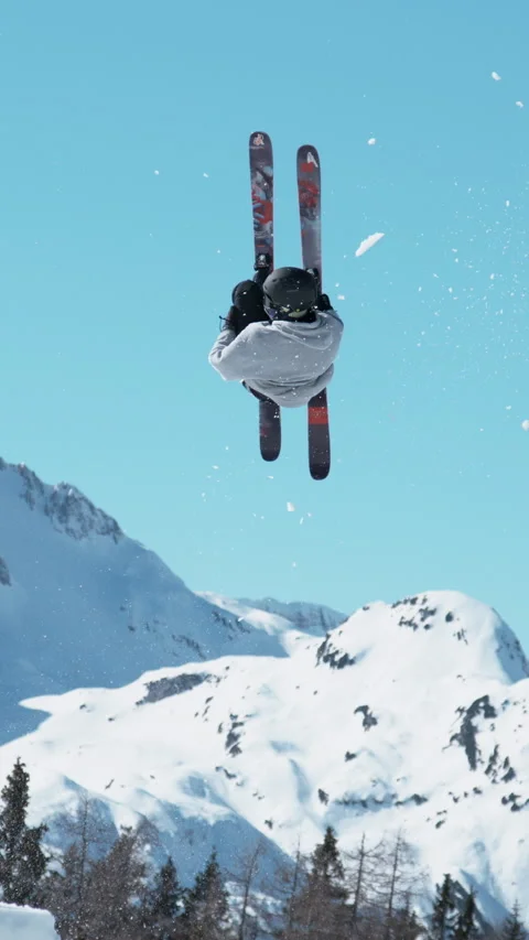 TIME WARP: Action shot of a freestyle skier taking off and doing a 360 grab. Stock Footage 295395366
