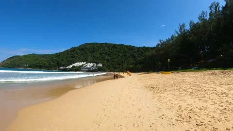 Time warp walk along the sandy beach, Nai Harn beach in Phuket on a sunny day Stock Footage 172413166