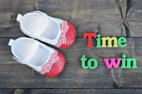 Time to win on wooden table 写真素材