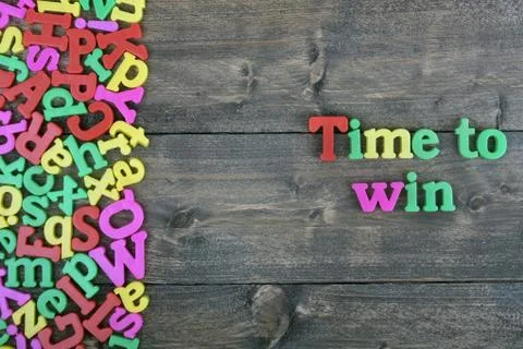 Time to win on wooden table Stock Photos