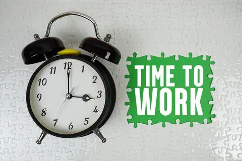 Time To Work text with alarm clock on green background Stock Photos