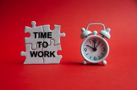 Time to work text on jigsaw puzzle with alarm clock pointing at 10 o'clock... Stock Photos