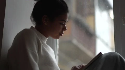 Time for yourself. Attractive young mixed race woman reading a book and looking Stock Footage 146203467