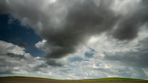 Timelabs. Gray clouds thicken over the field in the sky Stock Footage 250044154
