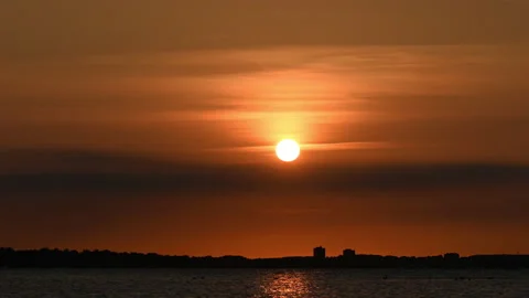 Timelaps 60fps video of sunset orange sun and sky at Baltic sea  and water Stock Footage 160351975