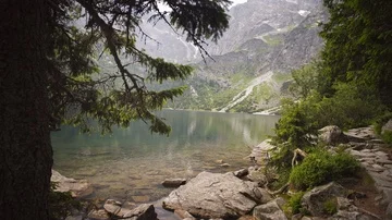 Timelaps camera slide of lake and mountains among the clouds and trees 4k HDR Stock Footage 85565329