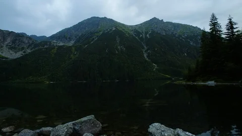 Timelaps of clouds passing over the lake among the mountains 4k HDR H264 Stock Footage 88315912