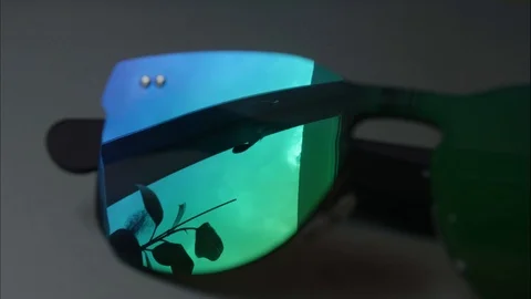 Timelaps of clouds running in sky in reflection of sunglasses. suumer is around Stock Footage 114613890