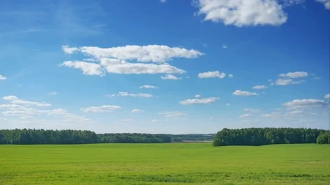 TimeLaps. Clouds swim over green fields Stock Footage 76259881