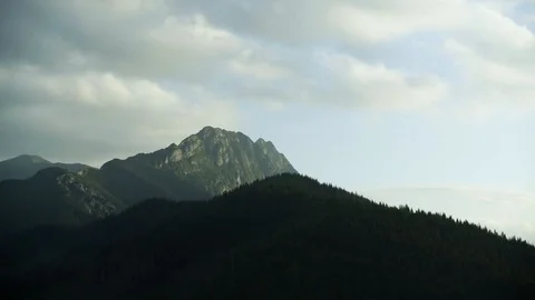 Timelaps of forest and the top of the mountain with a cross among clouds - Giewo Stock Footage 88323761