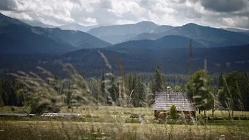 Timelaps of mountains with the hut. Grass fluttering in the wind. 4K HDR H264 Stock Footage 85575019