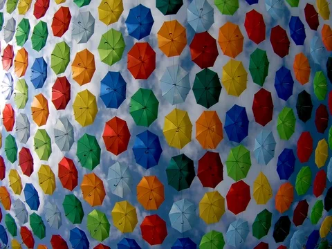 Timelaps multicolored hanging umbrellas against the blue sky Stock Footage 95734709