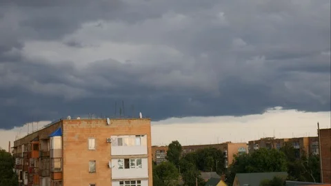 Timelaps stormy, dark, gray clouds move quickly over the city Video stock 115986553