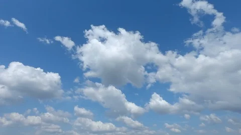 Timelaps video with fast-running fluffy white clouds on a bright blue sky Stock Footage 118937271