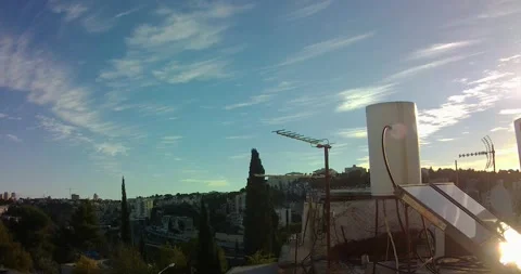 Timelaps, winter clouds move rapidly over a solar water heater Stock Footage 168576049