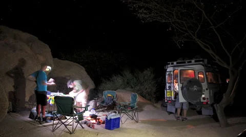 TIMELAPSE 3 PEOPLE AT NIGHTCAMP MAKING FOOD UHD 4K Stock Footage 45343558