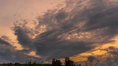 Timelapse 4K: Dramatic dark cloud formation with a yellow sky at sunset Stock Footage 127087374