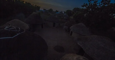 Timelapse 4K - Sun rises over African huts in a Ghanaian village Stock Footage 100375676