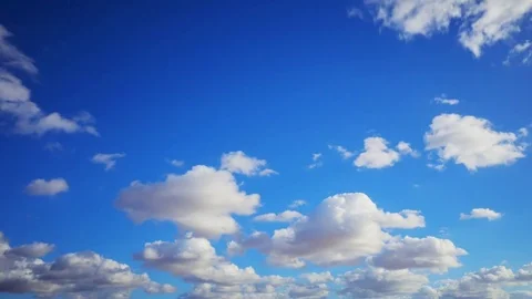 Timelapse Aerial Shot Of Fluffy Clouds Rolling Over Blue Sky Stock Footage 72342644