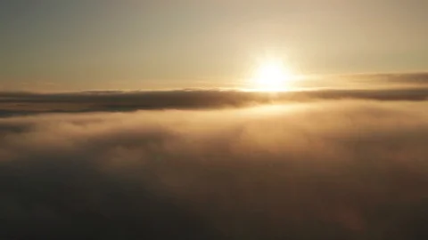 Timelapse aerial view above the clouds at sunrise for a spectacular establisher Stock Footage 118591195