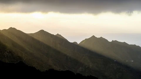Timelapse aerial view of dramatic sunrise clouds running over mountains in An Stock Footage 121197941