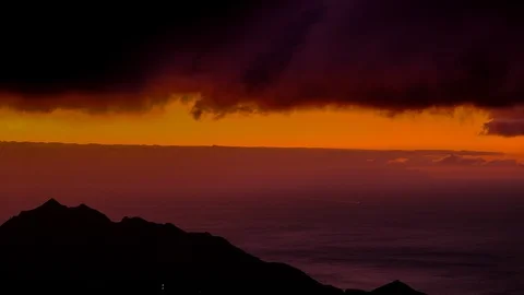 Timelapse aerial view of dramatic sunrise clouds running over mountains in An Stock Footage 121197959