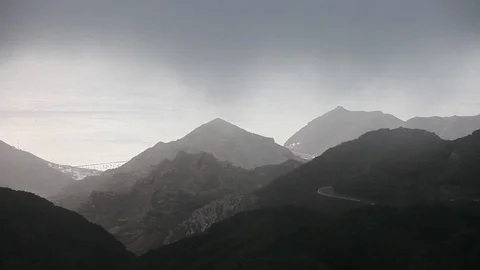 Timelapse aerial view of dramatic sunrise clouds running over mountains in An Stock Footage 121198754