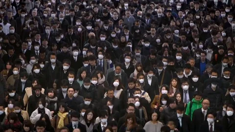 Timelapse aerial view of large crowd people wearing surgical mask walking.-Dan Stock Footage 124398175