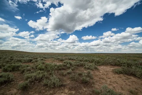 Timelapse afternoon clouds racing over sage brush prairie in Montana Stock Footage 62061623