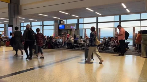 Timelapse as airline passengers walk through a busy airport terminal Stock Footage 256244688