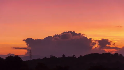 Timelapse - Amazing colour explosion behind clouds 4K30 Stock Footage 271198644
