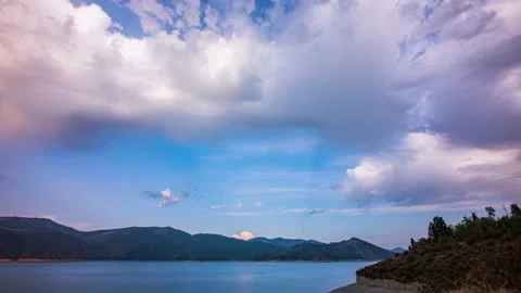 Timelapse - Amazing mountain landscape  with dramatic clouds above the lake Stock Footage 145521386