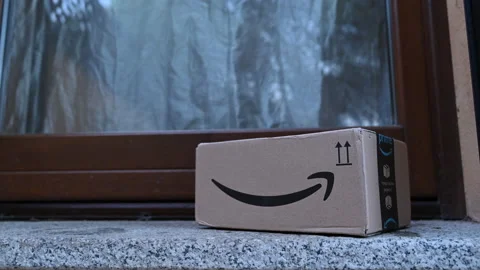 Timelapse of Amazon prime parcel delivery box left in front of the main door Stock Footage 155248777
