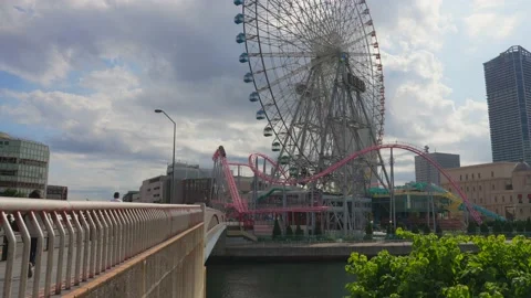 Timelapse amusement park roller coaster ferris wheel clouds roll by Stock Footage 228755405