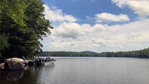 Timelapse and pan across beautiful New England lake with puffy clouds Stock Footage 111400518