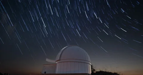 Timelapse of an astronomical observatory under star trails sky at night Stock Footage 204000986