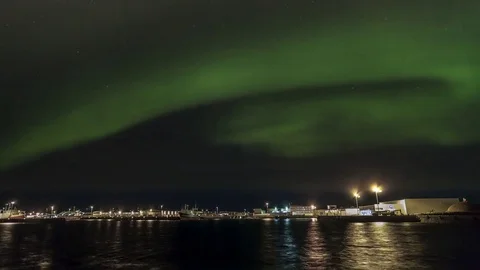 Timelapse of aurora borealis glowing over hofnin harbor Stock Footage 73010683
