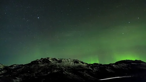 Timelapse of aurora borealis moving over rocks Stock Footage 73010647