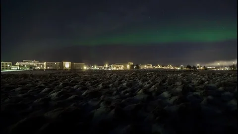 Timelapse of aurora borealis over snowy landscape Stock Footage 73011997