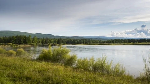 Timelapse. Autumn landscape of fast river with moving clouds in the blue sky Stock Footage 115077489