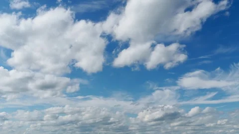 Timelapse background of white clouds moving across blue sky Stock Footage 341737662